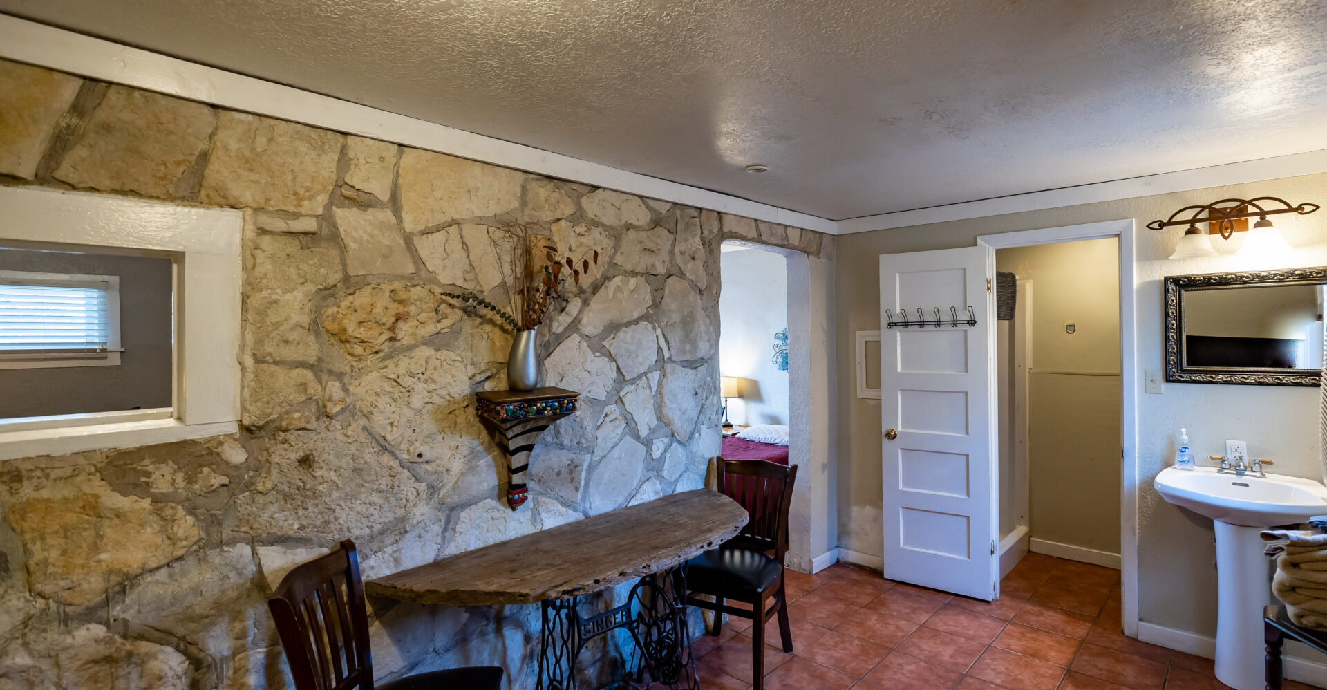 A inside of a house with stone wall design and white interiors